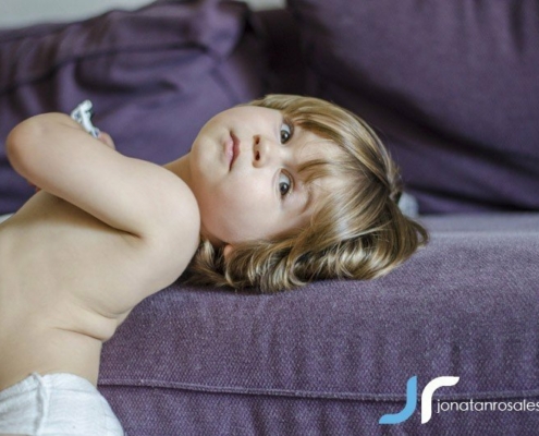 kid laying in sofa