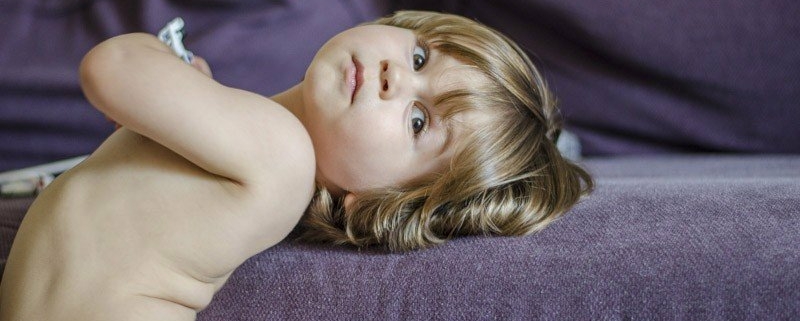 kid laying in sofa