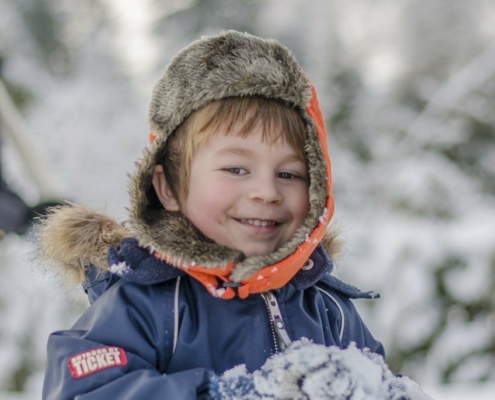 Cute boy smiling in the snow