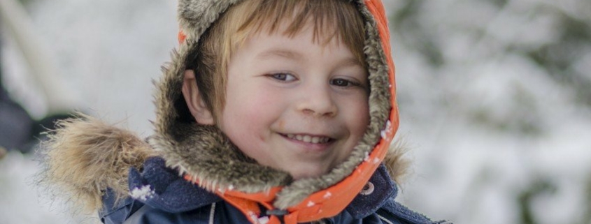 Cute boy smiling in the snow